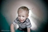 Trey in the playground\'s tunnel